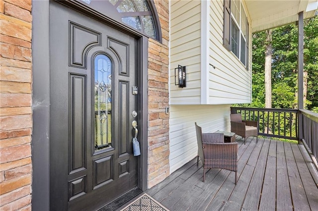 view of exterior entry with covered porch