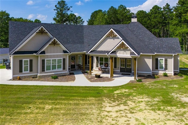 rear view of house with a patio and a lawn