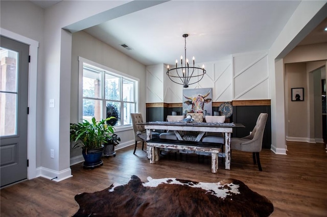 dining area featuring dark hardwood / wood-style floors and a notable chandelier