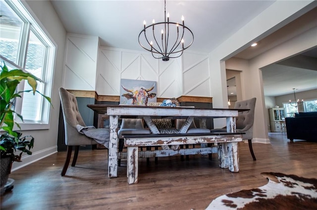 dining area featuring dark hardwood / wood-style flooring and a chandelier