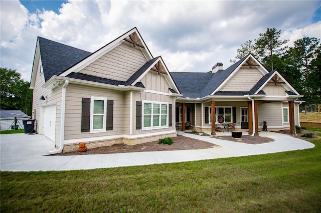 rear view of property with a yard and a garage