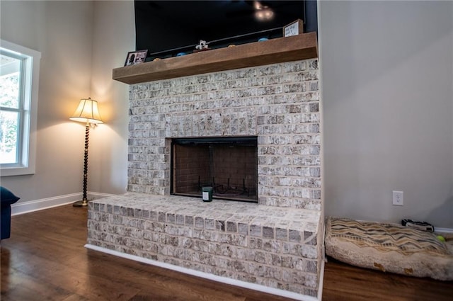 room details with hardwood / wood-style floors and a brick fireplace