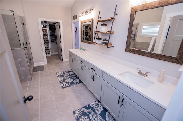 bathroom with tile patterned floors, vanity, and a shower with shower door