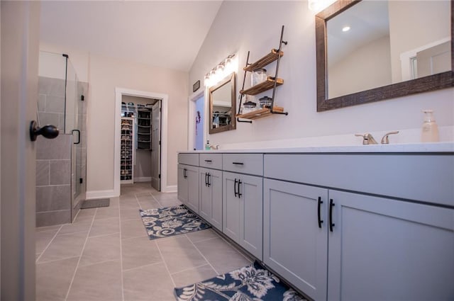 bathroom with tile patterned floors, vanity, an enclosed shower, and vaulted ceiling