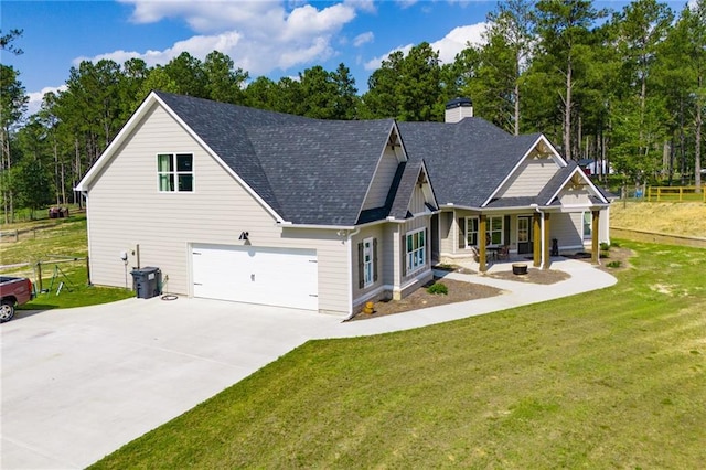 view of front of house featuring a garage and a front lawn