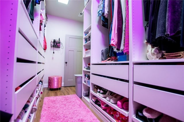 walk in closet featuring light hardwood / wood-style floors