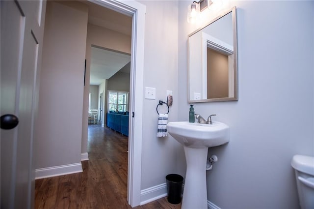 bathroom featuring sink, toilet, and hardwood / wood-style floors