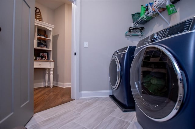 clothes washing area featuring separate washer and dryer and light wood-type flooring