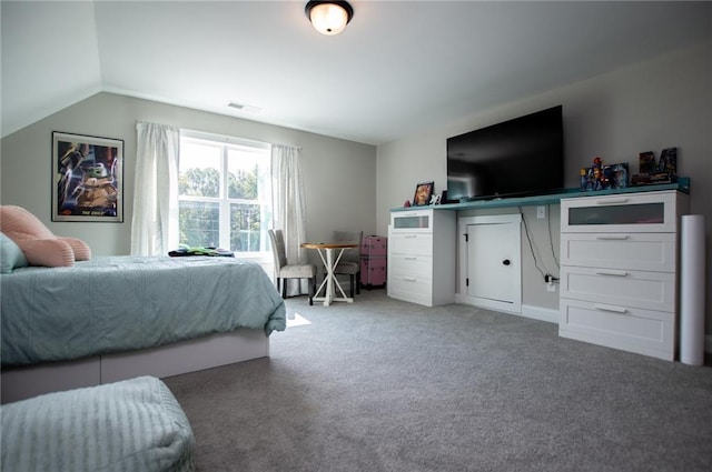 carpeted bedroom with lofted ceiling