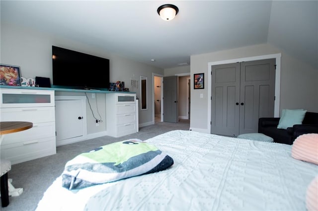 bedroom featuring light colored carpet and a closet