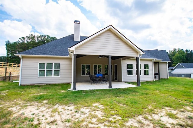 back of house featuring a patio, a yard, and ceiling fan