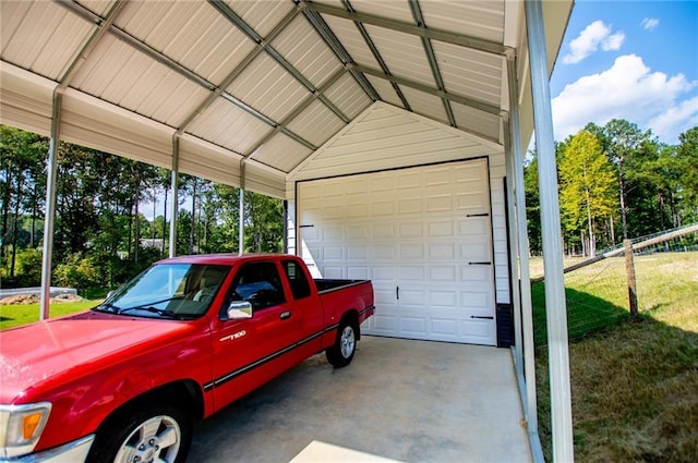 garage with a carport and a yard