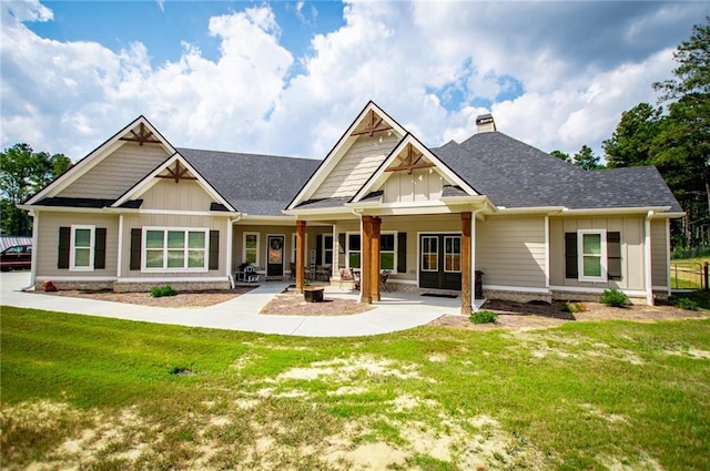 rear view of property featuring a lawn