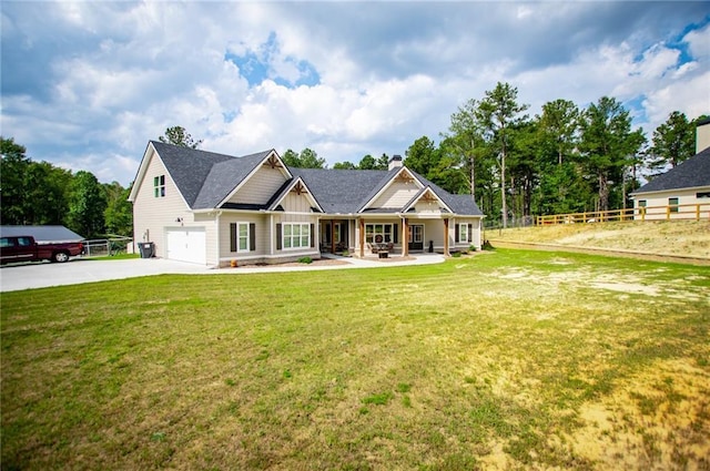 craftsman house featuring a garage and a front yard