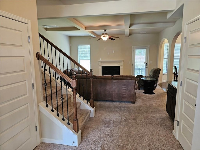 1750 Stone Meadow Rd, Lithonia, GA 30058 - carpeted living room featuring a ceiling fan, coffered ceiling, beam ceiling, stairs, and a fireplace