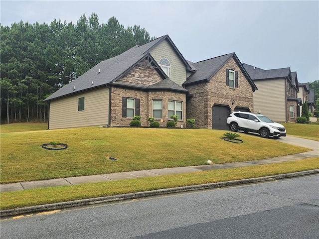 view of front of home featuring an attached garage, driveway, brick siding, and a front yard