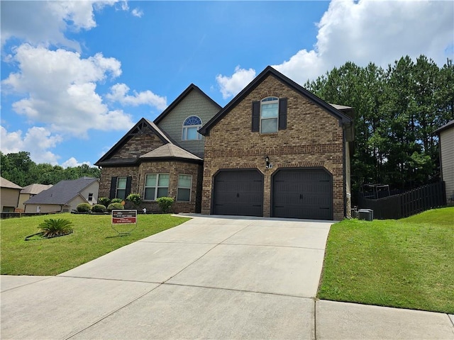 1750 Stone Meadow Rd, Lithonia, GA 30058 - view of front facade with a front yard, concrete driveway, a garage, and brick siding