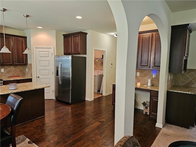 1750 Stone Meadow Rd, Lithonia, GA 30058 - kitchen with stainless steel refrigerator with ice dispenser, dark brown cabinets, dark wood-style flooring, light stone countertops, and tasteful backsplash