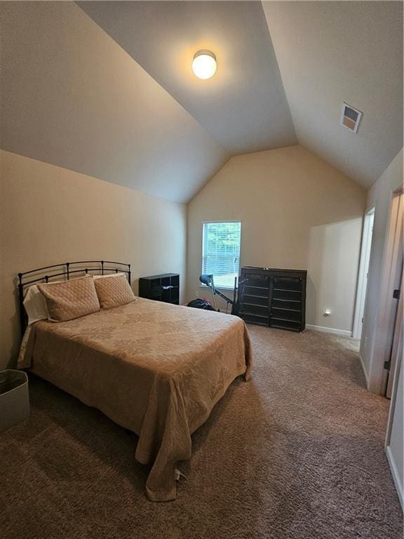 bedroom featuring carpet, lofted ceiling, and baseboards