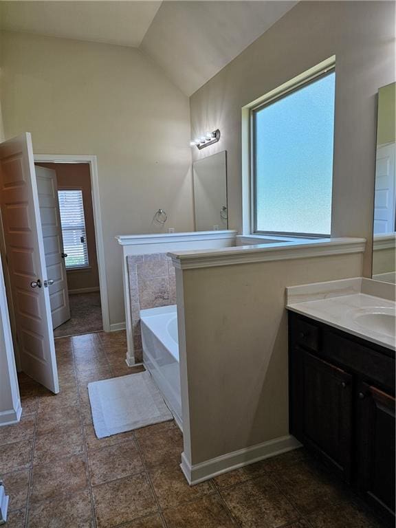 1750 Stone Meadow Rd, Lithonia, GA 30058 - bathroom with healthy amount of natural light, a bath, lofted ceiling, vanity, and tile patterned flooring