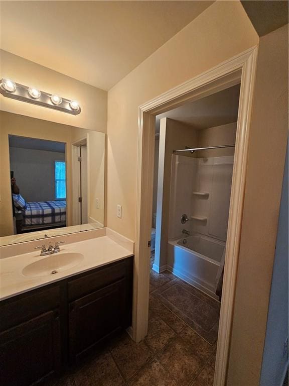 ensuite bathroom featuring vanity,  shower combination, and tile patterned flooring