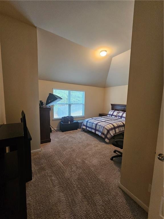 bedroom featuring carpet flooring, lofted ceiling, and baseboards