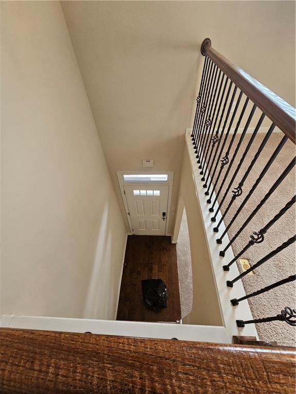 stairs featuring baseboards and wood finished floors