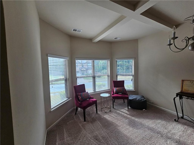 living area with carpet floors, beamed ceiling, and baseboards
