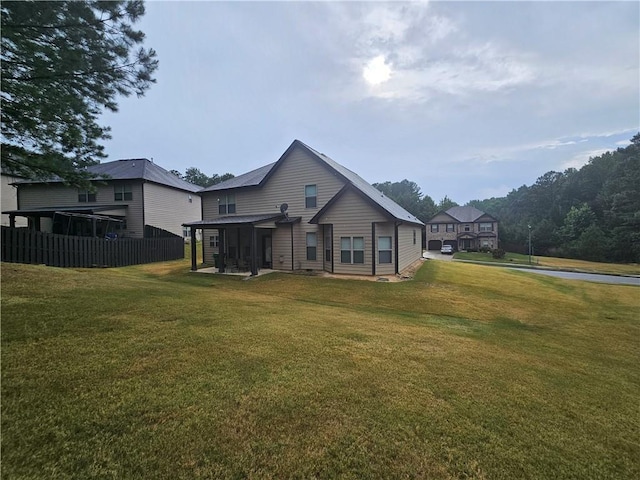 rear view of property with a lawn