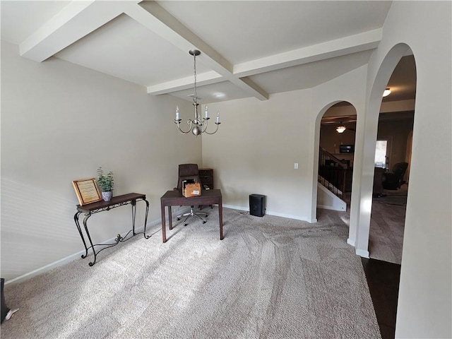 living area featuring arched walkways, carpet floors, baseboards, beam ceiling, and a desk