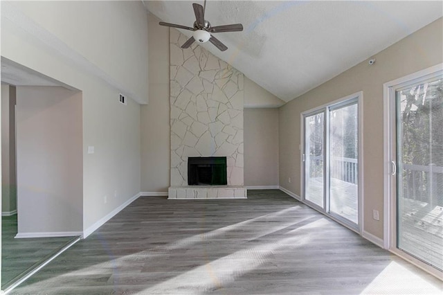 unfurnished living room featuring dark wood-style floors, visible vents, a fireplace, and baseboards