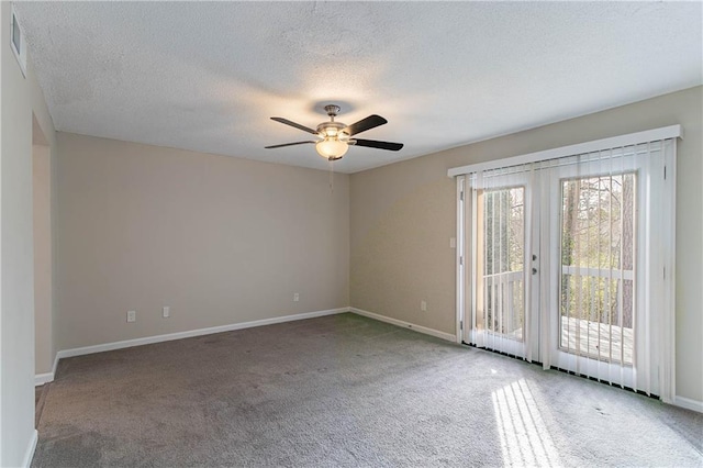 carpeted empty room featuring baseboards, visible vents, ceiling fan, a textured ceiling, and french doors