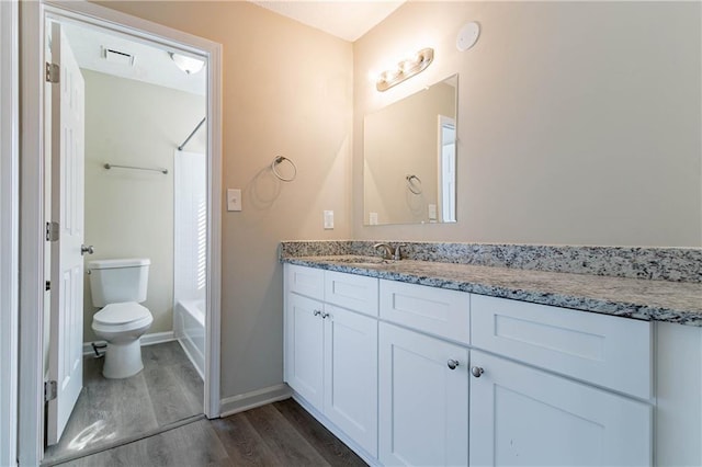 full bath with visible vents, toilet, wood finished floors, tub / shower combination, and vanity