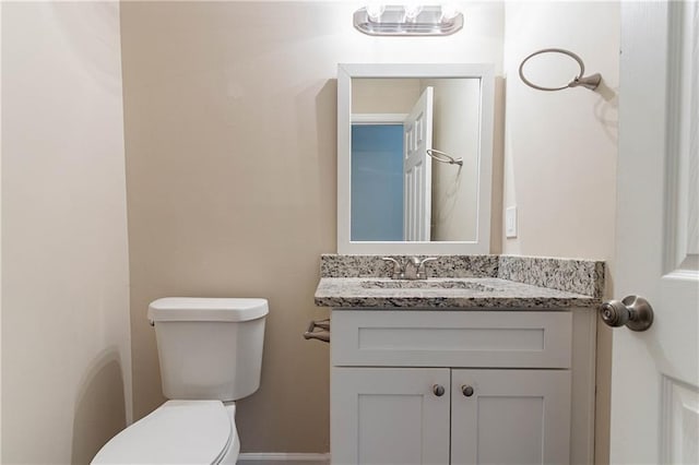 bathroom featuring toilet and vanity