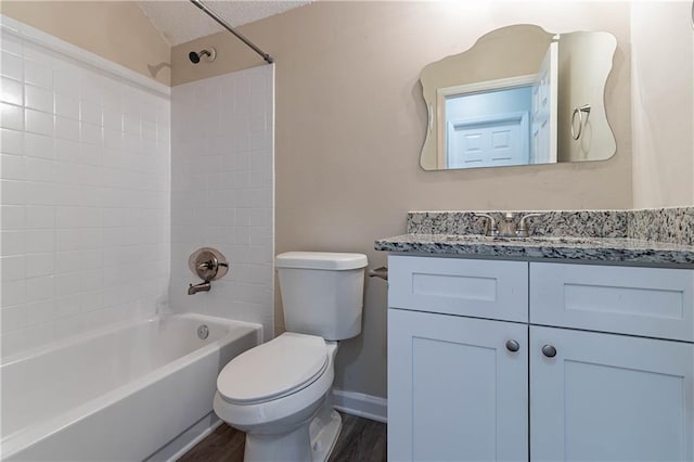 full bath featuring shower / bath combination, toilet, wood finished floors, a textured ceiling, and vanity