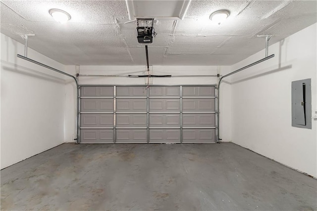 garage featuring electric panel and a garage door opener