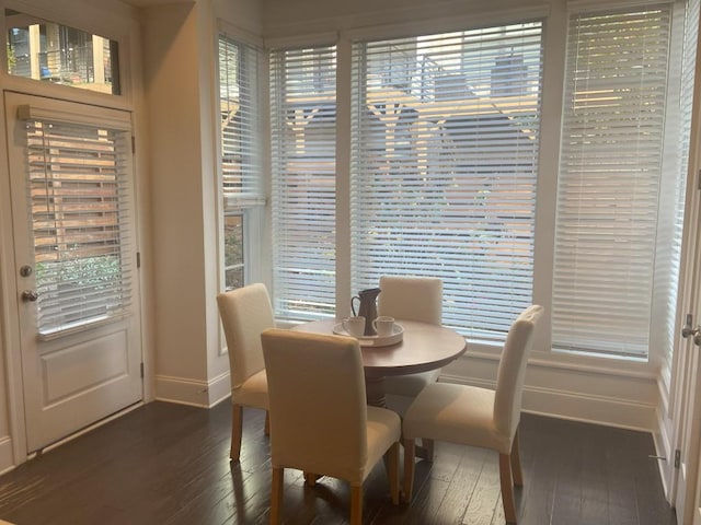 dining area featuring dark hardwood / wood-style floors and a healthy amount of sunlight