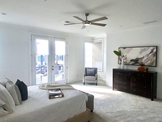 bedroom with ceiling fan, light colored carpet, access to outside, and french doors