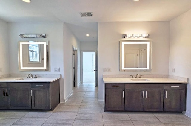 bathroom featuring tile patterned flooring and vanity