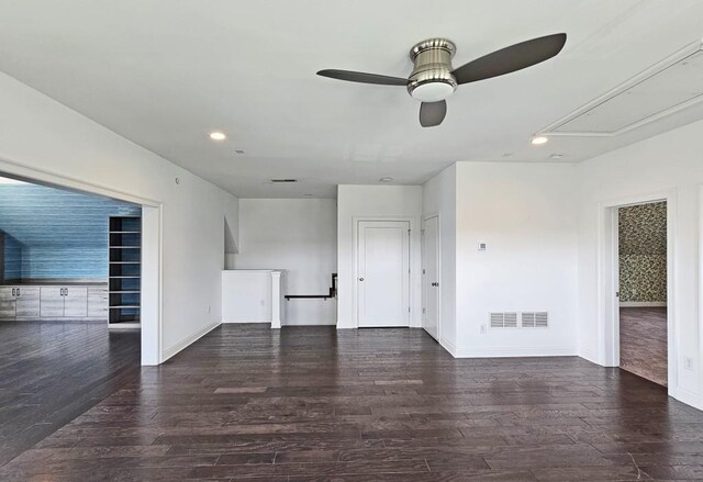 unfurnished living room featuring ceiling fan and dark wood-type flooring