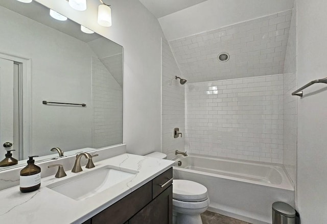 full bathroom with vanity, toilet, and tiled shower / bath