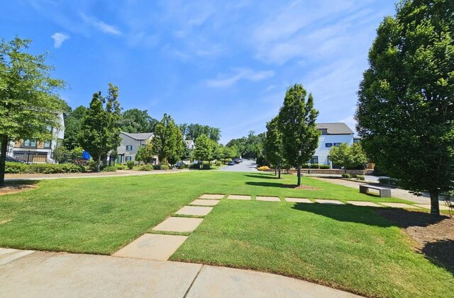 view of property's community with a lawn