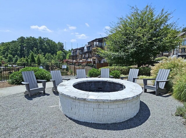 surrounding community with an outdoor fire pit and a patio