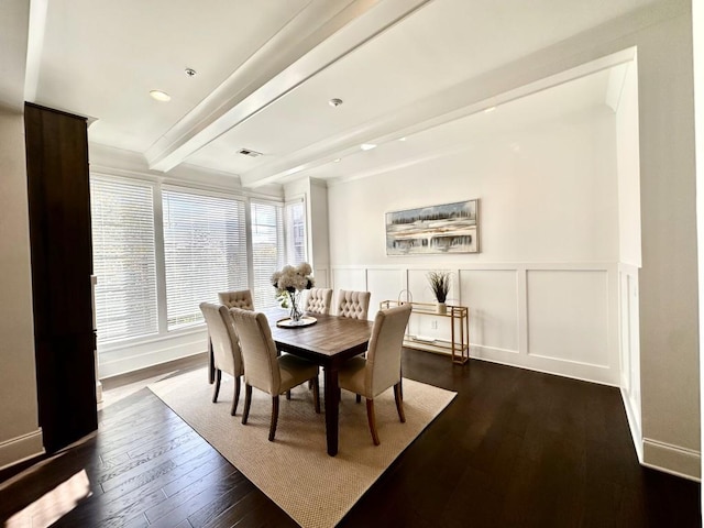 dining area featuring beam ceiling and dark wood-type flooring