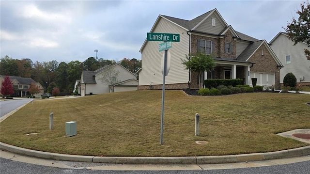 view of front of property featuring a front yard and a garage
