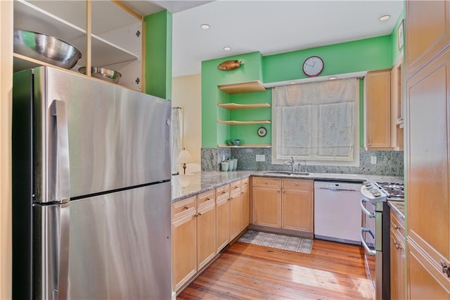 kitchen featuring a sink, appliances with stainless steel finishes, light brown cabinetry, open shelves, and tasteful backsplash