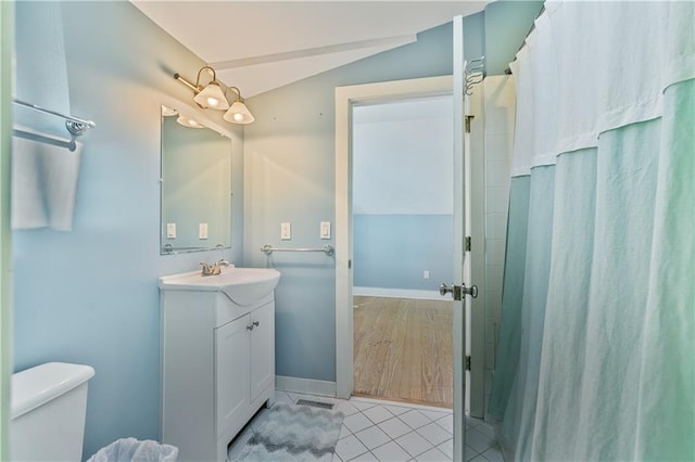 full bathroom with tile patterned flooring, vaulted ceiling, vanity, and a shower with shower curtain