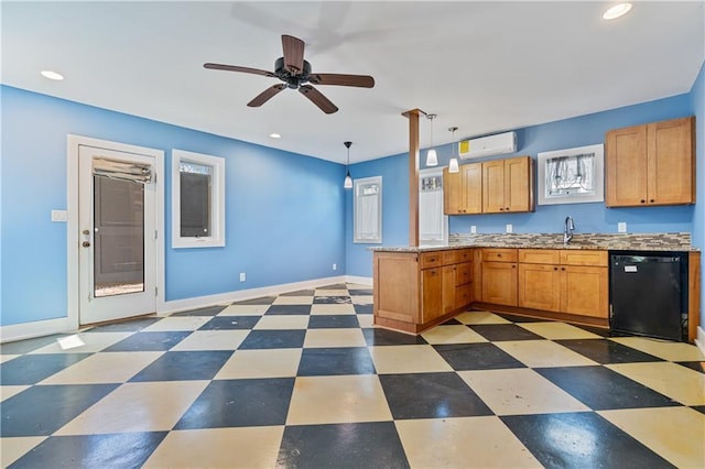 kitchen with a peninsula, a sink, black dishwasher, light floors, and a wall mounted air conditioner