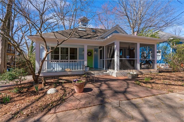 view of front of home featuring a sunroom and a porch