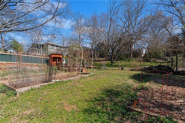 view of yard featuring a vegetable garden and fence